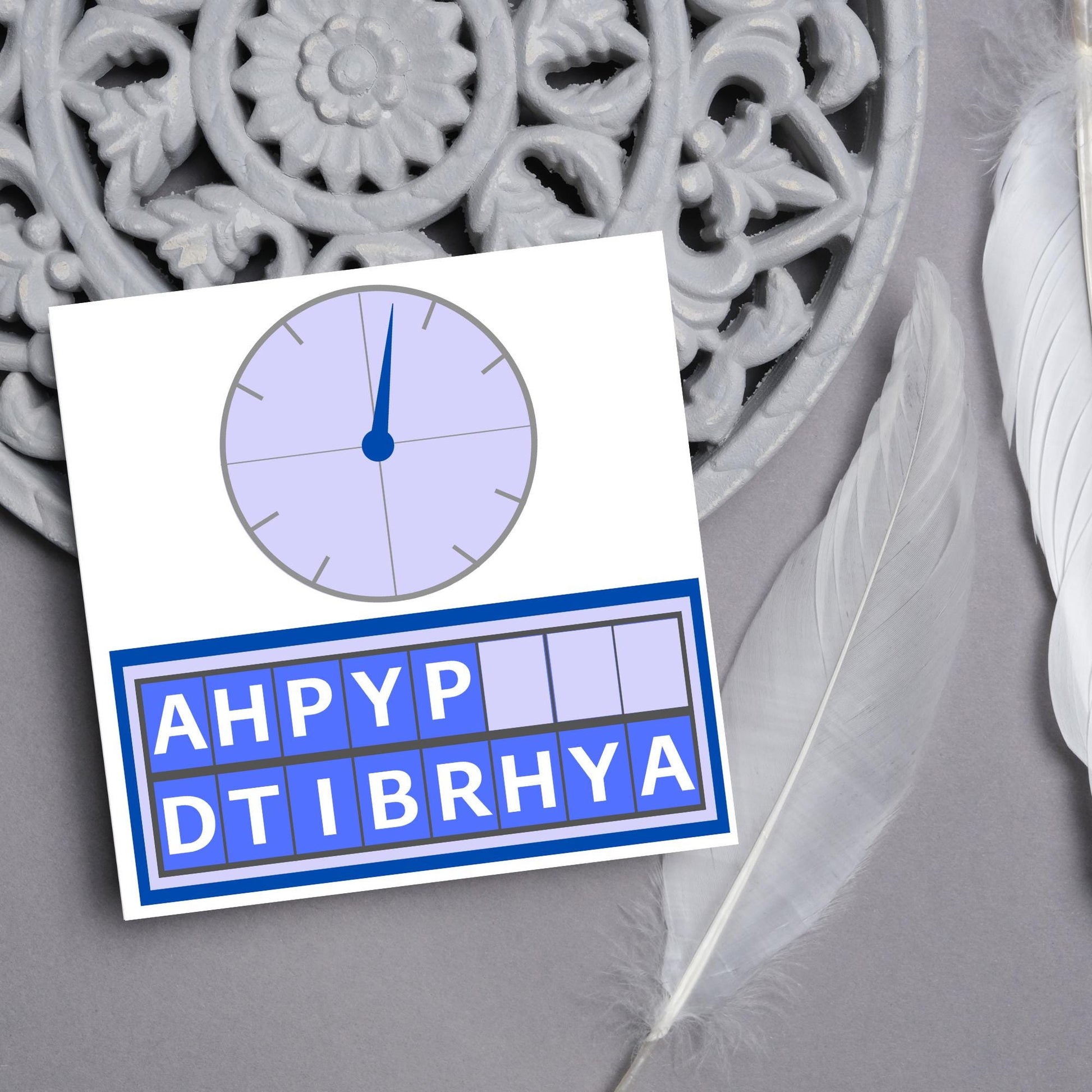 Square birthday card with a countdown theme with the clock and jumbled up letters that spell happy birthday