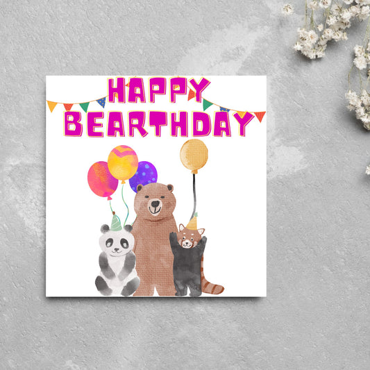 Image of a square Birthday Card. The card has a white background with a vibrant watercolour illustration of 3 bears holding balloons and big pink text that reads happy bearthday, a cute play on the traditional happy birthday.