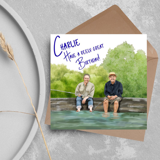 square greetings card with a hand drawn image of bob Mortimer and paul Whitehouse sitting on the edge of a dock fishing with their bare feet in the water. behind them are watercolour trees and bushes and blue text that reads &#39;charlie, have a freely great birthday&#39; in a handwritten style font